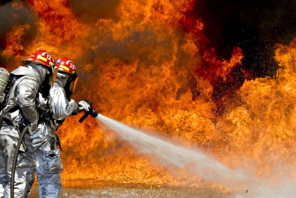 firefighter spraying fire with a hose